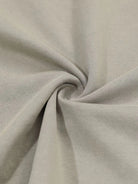 Distressed Grunge Layered T-Shirt featuring a close-up of beige knit fabric texture, showcasing its gathered texture, highlighting the layered camo sleeves and vintage graphic style.