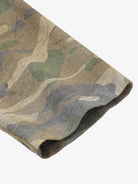 Close-up of Distressed Grunge Layered T-Shirt showcasing a camo-patterned long sleeve hem, highlighting its layered design and raw street style appeal.