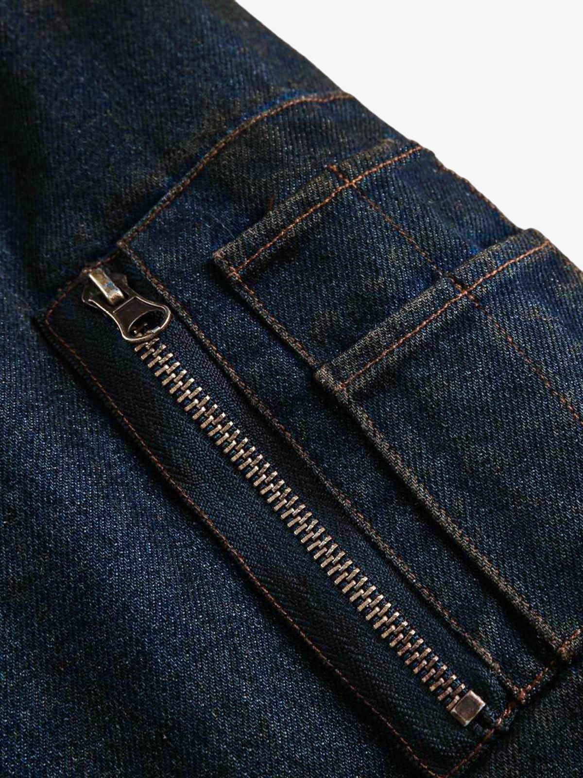 Close-up of Distressed Washed Faux Fur Winter Jacket, showing dark blue denim fabric with metal zipper and stitched pocket detail, highlighting its rugged texture.