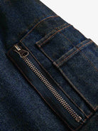Close-up of Distressed Washed Faux Fur Winter Jacket, showing dark blue denim fabric with metal zipper and stitched pocket detail, highlighting its rugged texture.