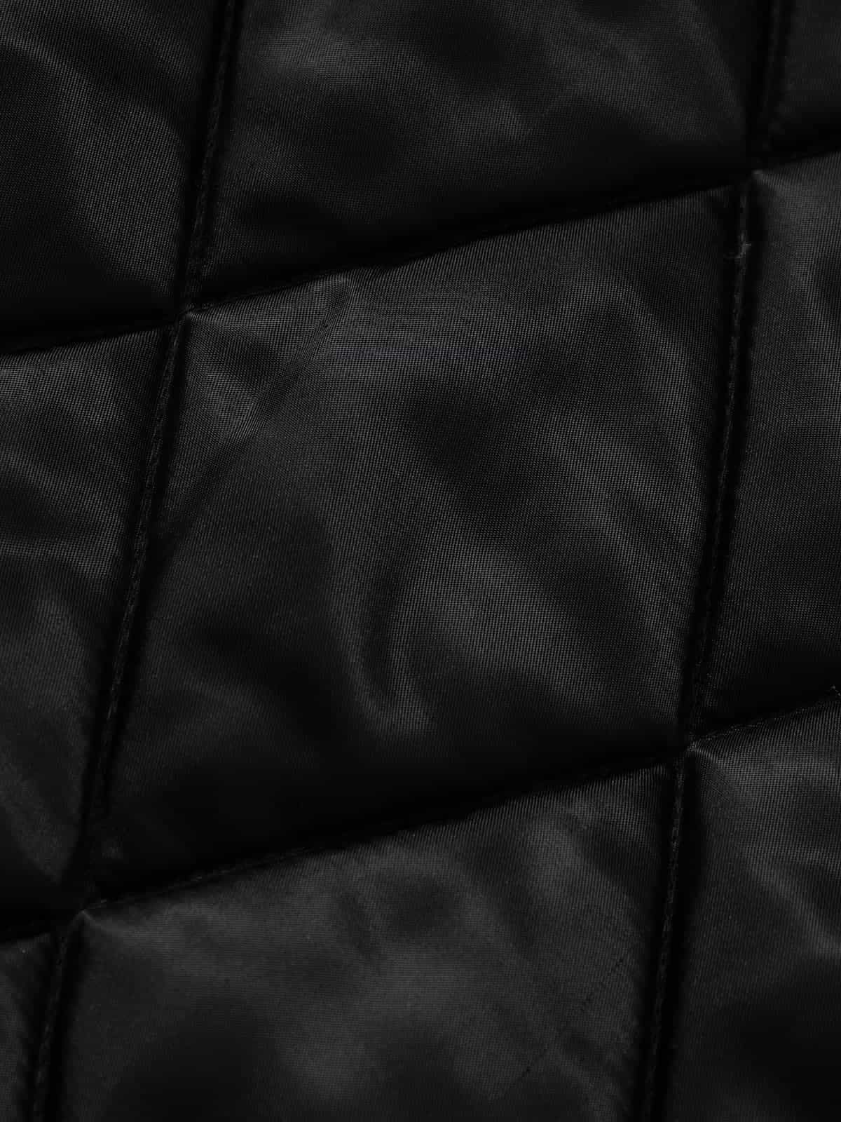 Graphic Graffiti High Neck Street Jacket featuring quilted black fabric with diagonal stitching, showcasing bold graffiti designs and a padded structure for a distinctive streetwear appeal.