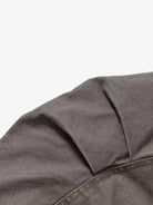 Close-up of the Graphic Graffiti High Neck Street Jacket, showcasing dark gray woven fabric with stitching and a pleat, highlighting its edgy streetwear style.