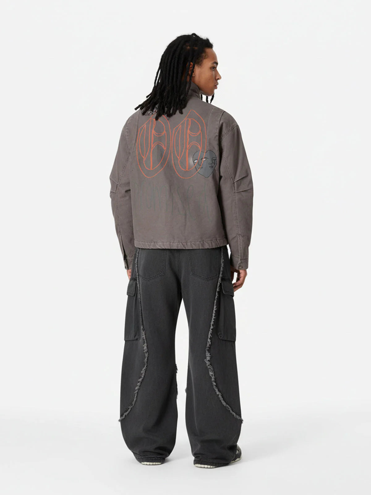 Graphic Graffiti High Neck Street Jacket features oversized line-art graphics, padded structure, and a high-neck silhouette, paired with loose-fitting charcoal-black cargo pants.