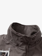 Close-up of the Graphic Graffiti High Neck Street Jacket, highlighting the textured charcoal fabric, stand-up collar, and snap-button tab, embodying bold streetwear style.