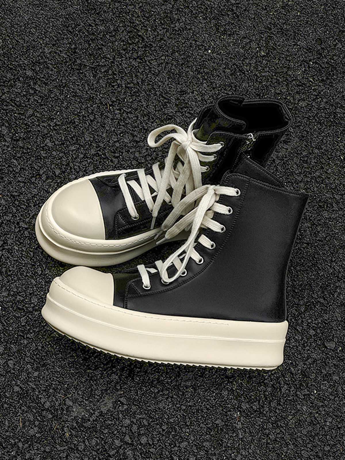 High-Top Platform Streetwear Sneakers with black uppers, oversized cream soles, and white laces, showcasing a bold silhouette for a modern streetwear look.