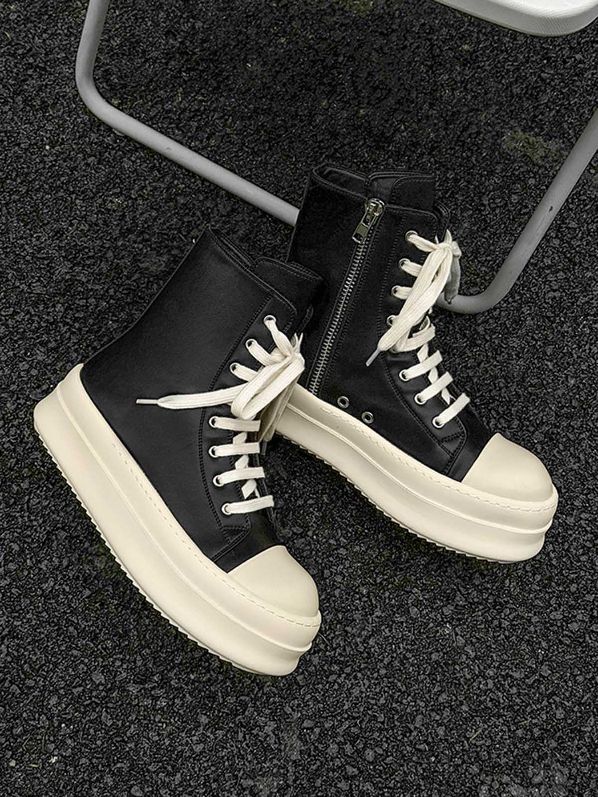 High-Top Platform Streetwear Sneakers featuring black high-top design with off-white chunky soles and laces, showcased on a rough asphalt surface for a bold, modern aesthetic.