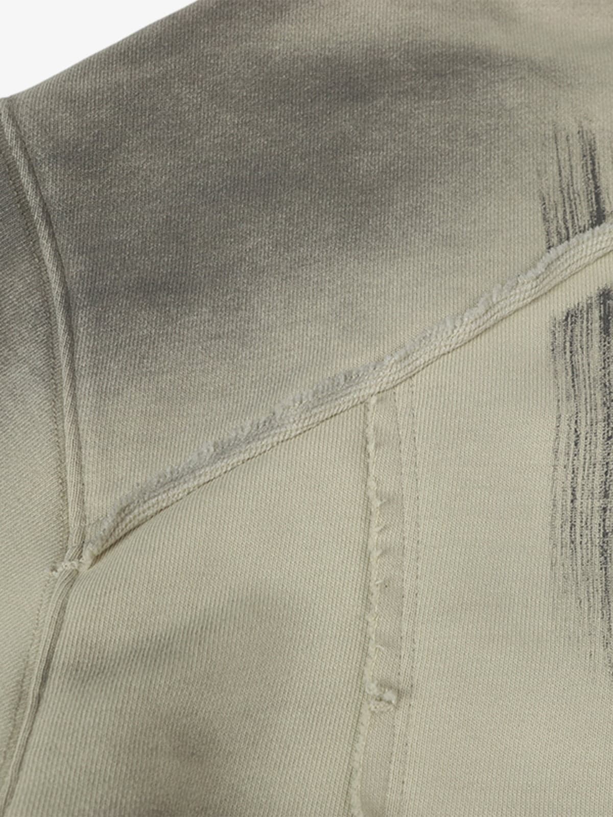 Ink Dyed Raw-Edge Streetwear Hoodie close-up showing diagonal and vertical seams, distressed areas, and ink-dyed fading for a rugged, oversized streetwear aesthetic.
