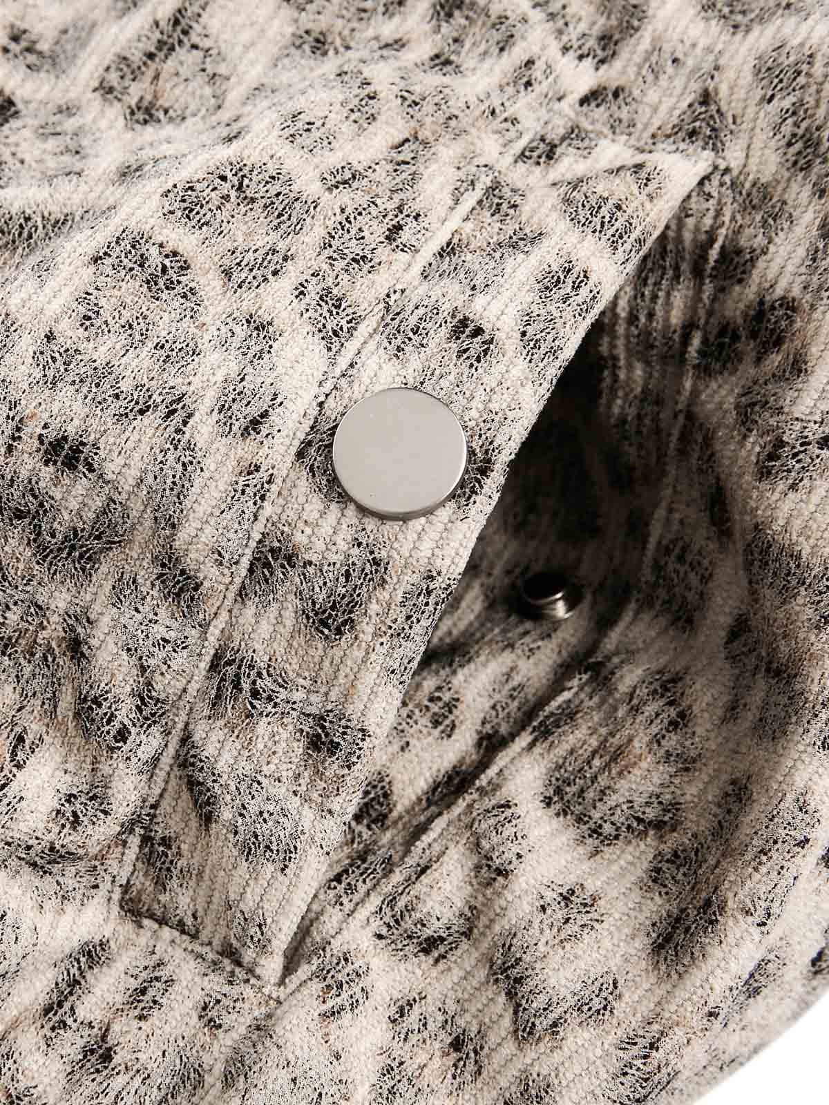 Close-up of Leopard Faux Fur Hooded Jacket fabric, showing muted animal print and silvery snap-button, hinting at the garment's stylish, textured design.