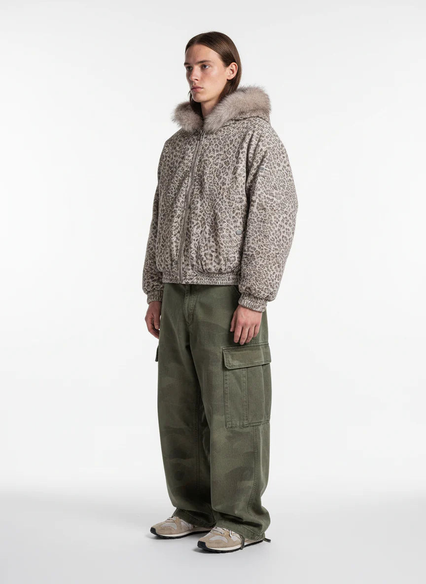 Model wearing Leopard Faux Fur Hooded Jacket with fluffy trim, paired with olive cargo pants and beige-grey sneakers, showcasing a stylish winter streetwear look.