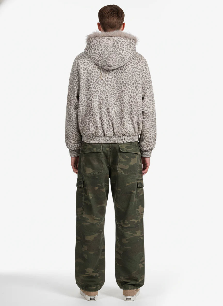 Person wearing Leopard Faux Fur Hooded Jacket with fur-trimmed hood, paired with camouflage cargo pants and low-top sneakers, showcasing a stylish winter streetwear look.