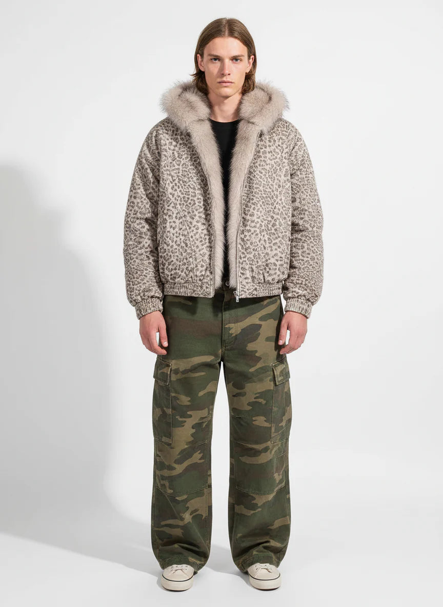 Young man wearing Leopard Faux Fur Hooded Jacket, showcasing its bold leopard print and fluffy hood, paired with camouflage cargo pants and sneakers.