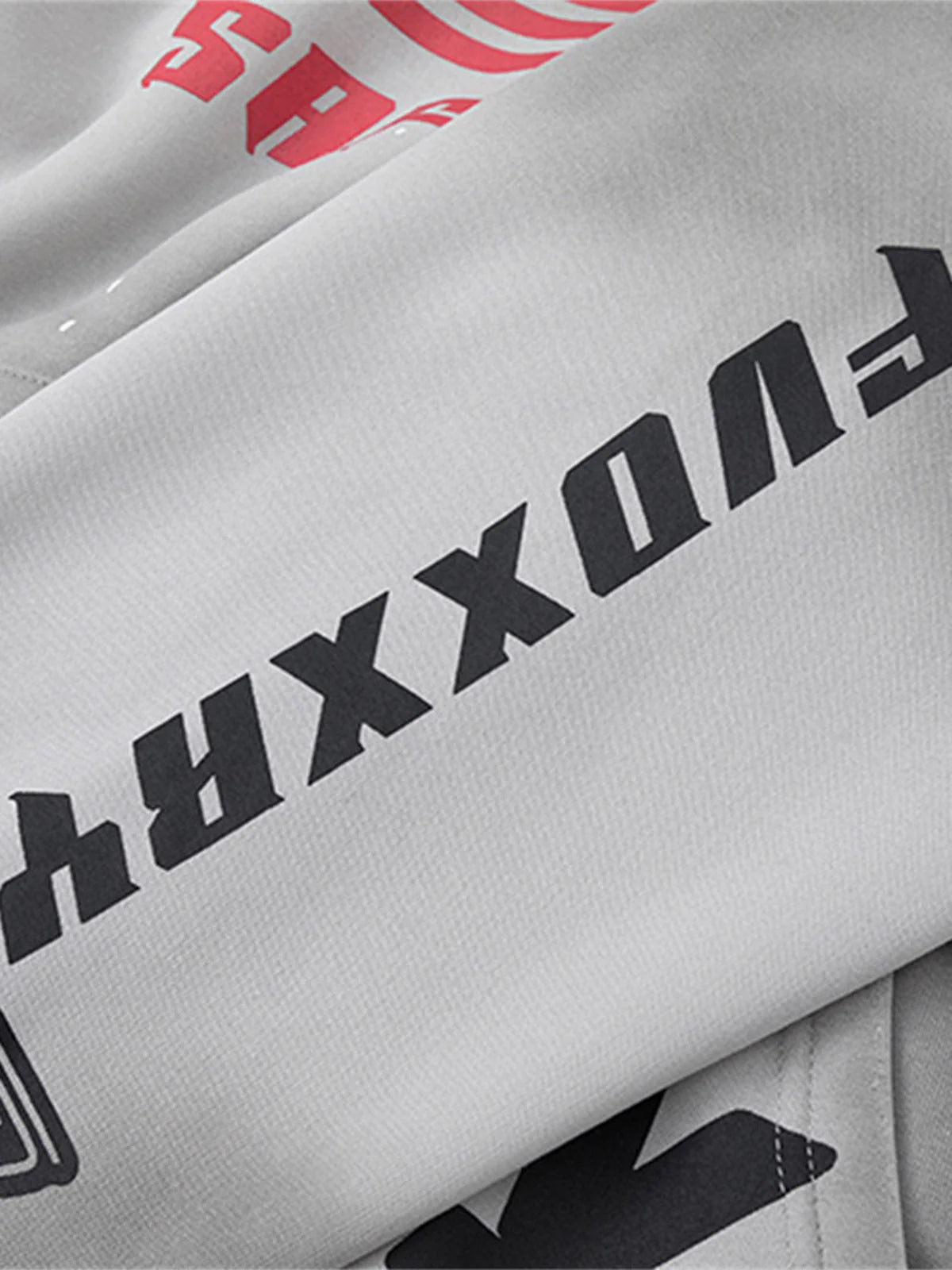 Racing Graphic Distressed Streetwear Hoodie featuring bold black and red block text on off-white fabric, showcasing oversized vintage racing-inspired graphics and distressed wash.