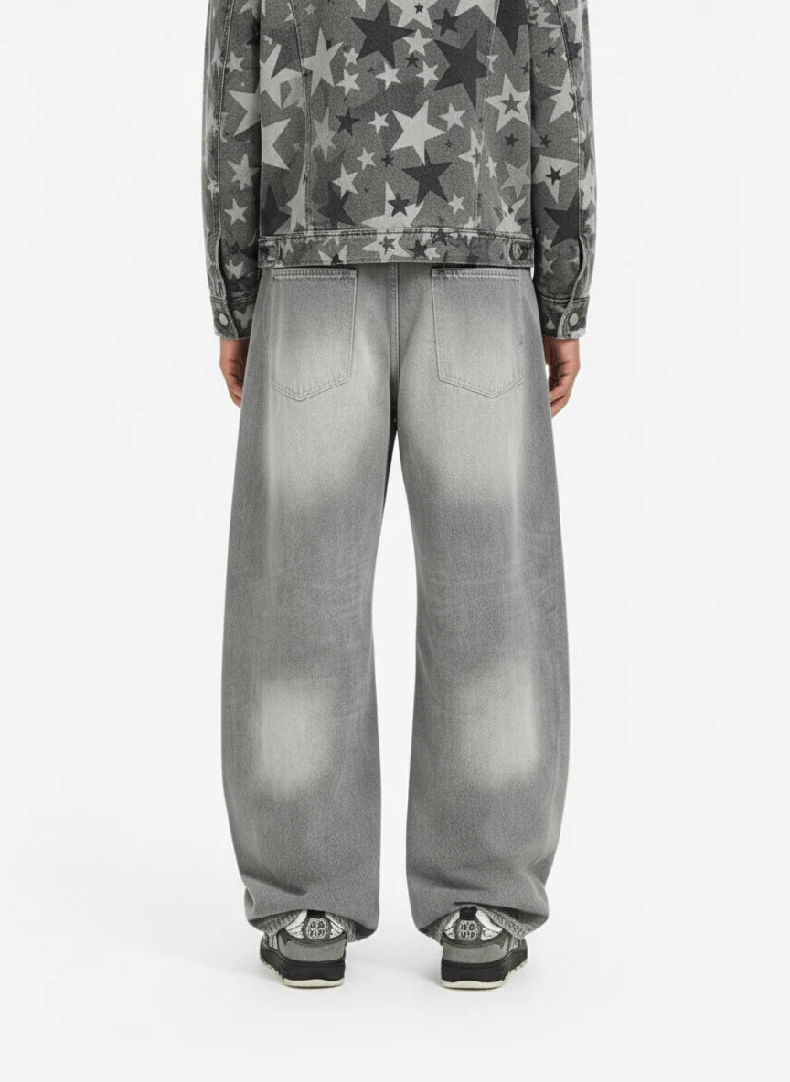 Back view of person wearing Retro Washed Grey Baggy Jeans, showcasing their wide, curved-leg silhouette and faded effect, paired with casual sneakers.