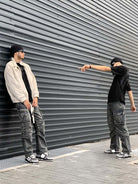 Young man in street style wearing Vintage Chunky Graphic Skate Shoes, showcasing their bold, low-top silhouette and graphic detailing in a modern urban setting.