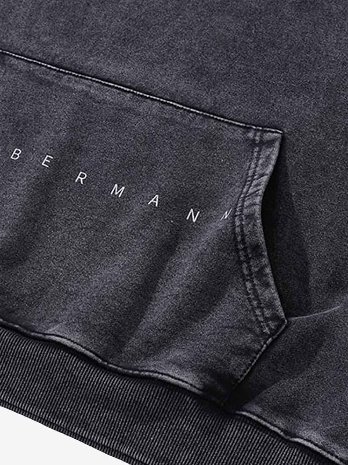 Close-up of the Vintage Doberman Graphic Streetwear Hoodie, showcasing the BERMANN lettering above the kangaroo pocket seam, highlighting its bold streetwear design.