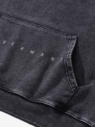 Close-up of the Vintage Doberman Graphic Streetwear Hoodie, showcasing the BERMANN lettering above the kangaroo pocket seam, highlighting its bold streetwear design.