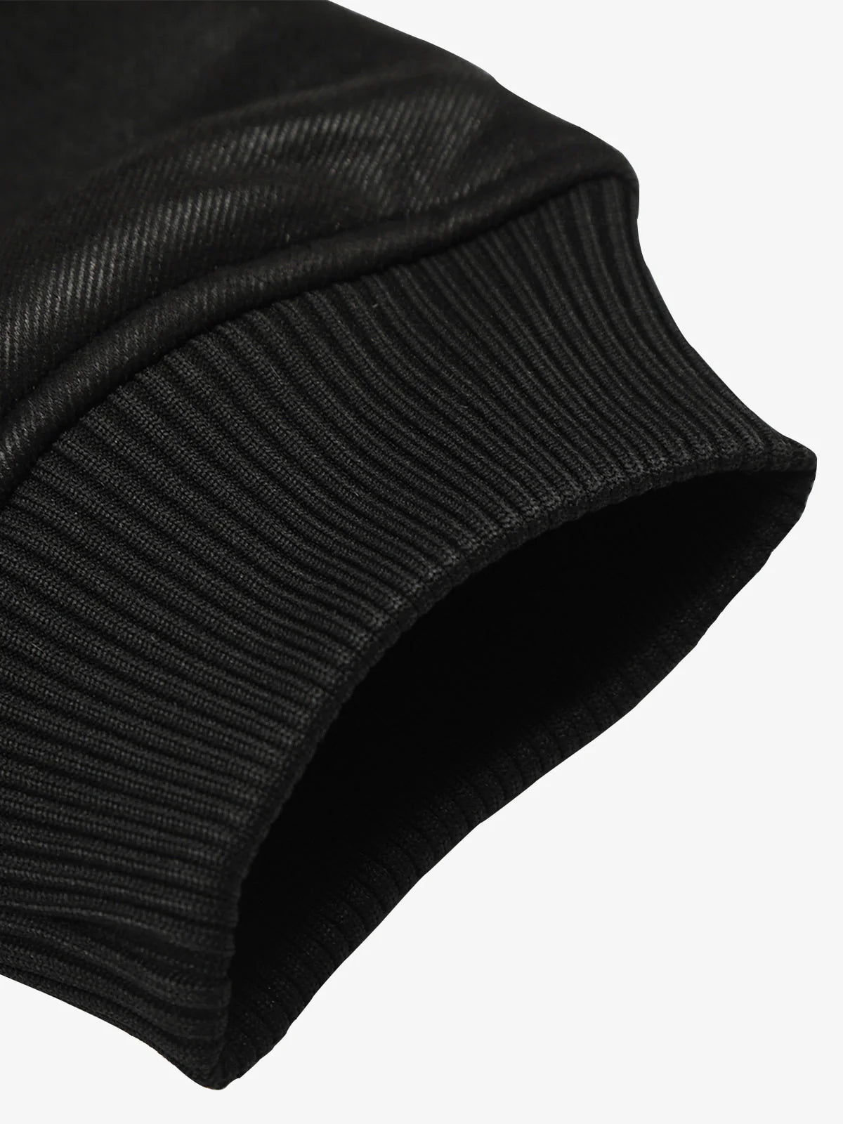 Close-up of a black, ribbed knit cuff on the Vintage Hooded Leather-Look Street Jacket, highlighting its retro streetwear style and warm fleece interior.