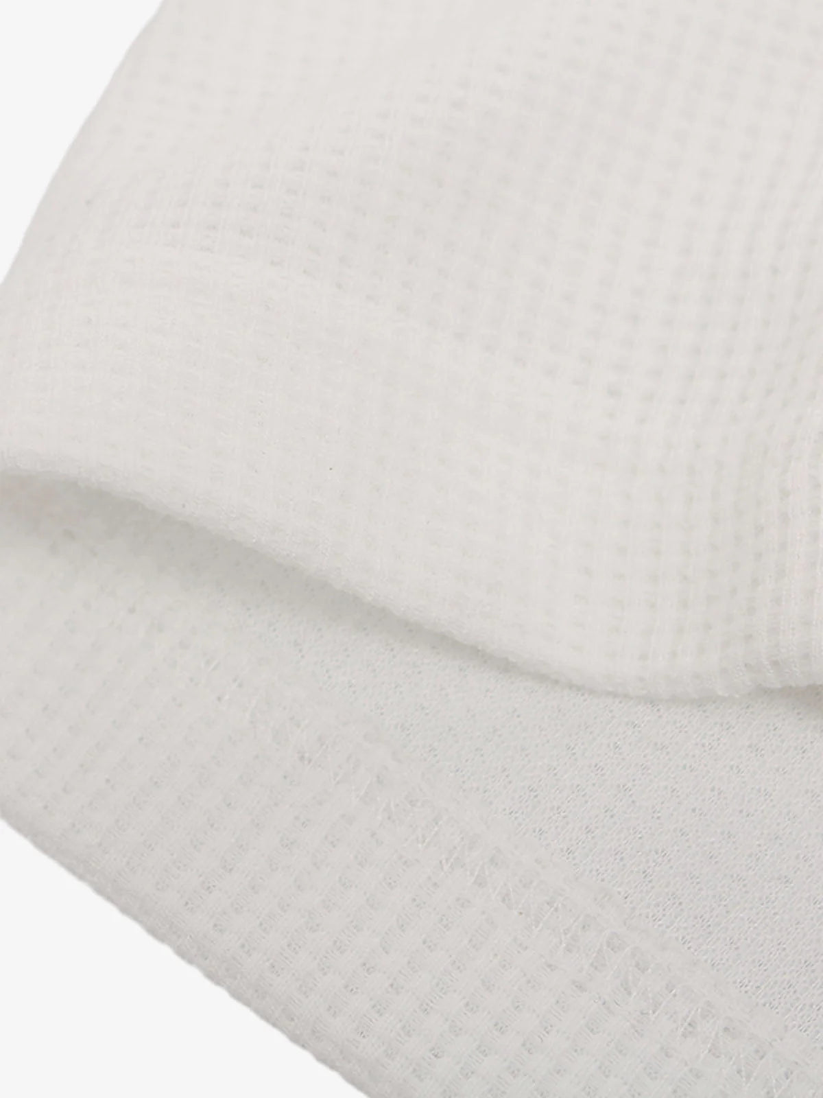 Close-up of Vintage Waffle Graphic Long-Sleeve T-Shirt, highlighting waffle-weave texture and stitched edge, embodying retro streetwear aesthetic with relaxed fit and vintage graphics.