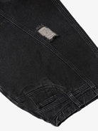 Close-up of Vintage Washed Baggy Ripped Jeans showcasing a distressed patch above the knee, emphasizing the oversized, relaxed streetwear silhouette.