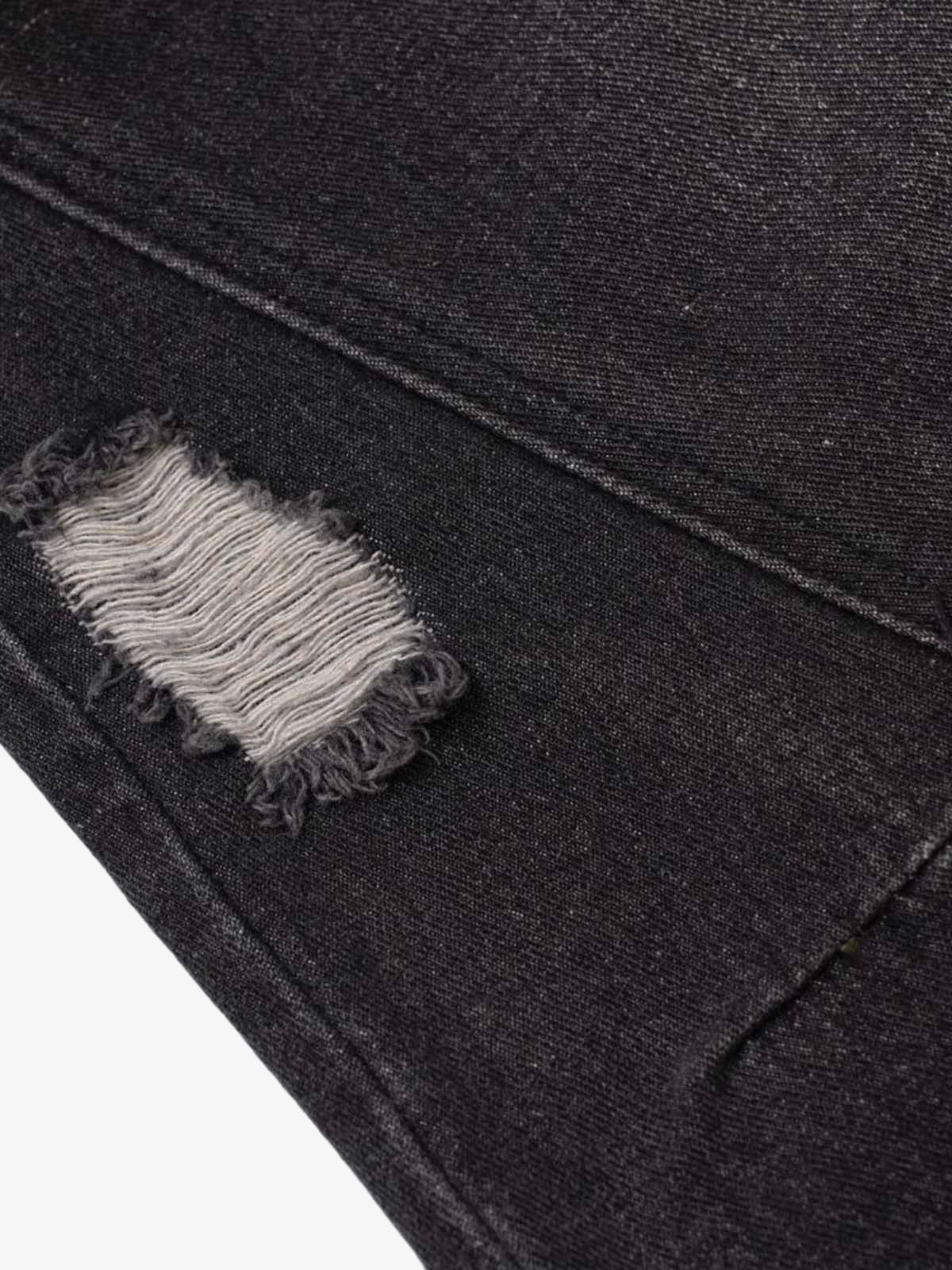 Close-up of Vintage Washed Baggy Ripped Jeans showing a distressed patch with frayed edges, revealing lighter threads, highlighting their grunge-inspired, oversized streetwear design.